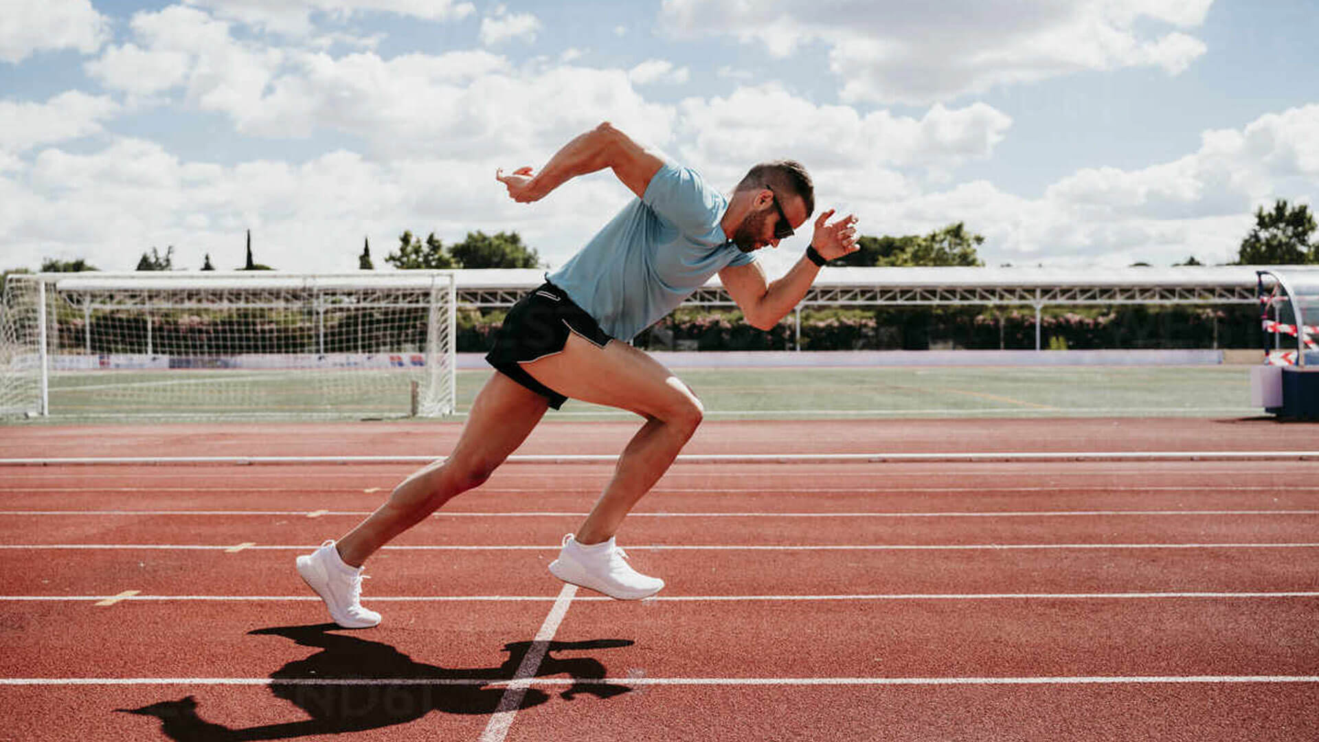 Athlete jogging on track after recovering from Achilles tendon injury